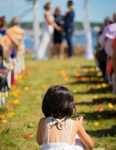 cute girl sitting down watching bride and groom pei photographer